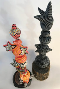 Photos "Tangerine Trees and Marmalade Skies," ceramic/mixed, 24 1/2” ht (left) and "Oh Monday, Monday, How Could You Leave...?," ceramic/mixed, 28” ht  (right) by Gayla Lemke